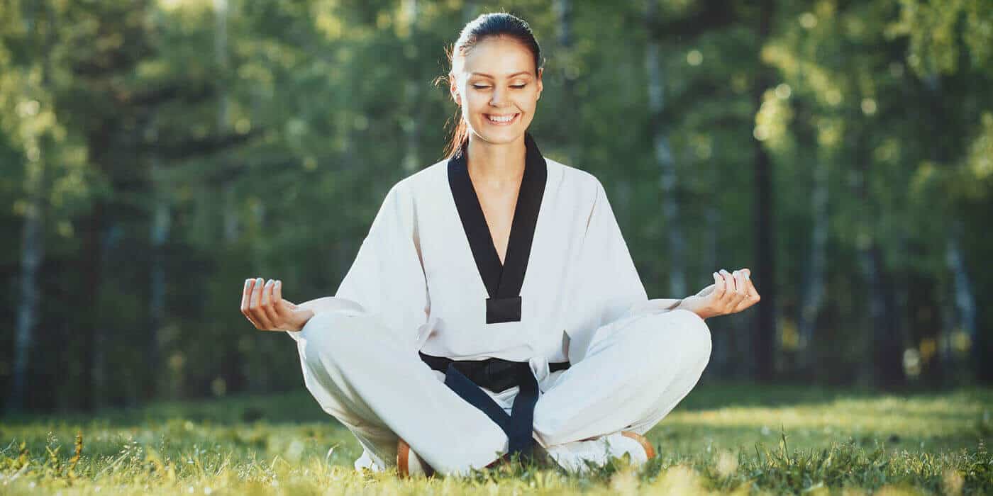 Martial Arts Lessons for Adults in Ramsey NJ - Happy Woman Meditated Sitting Background